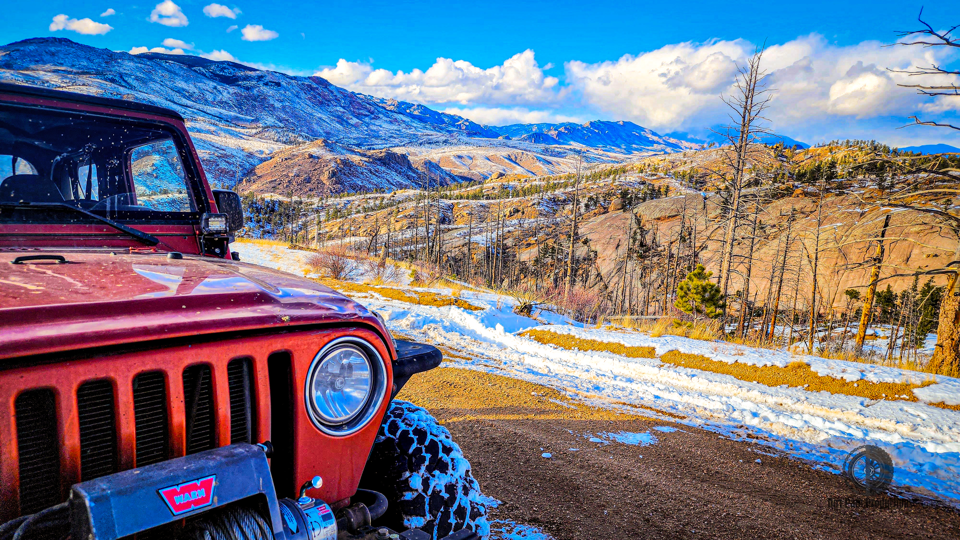 Jeep on mountain trail with sunset