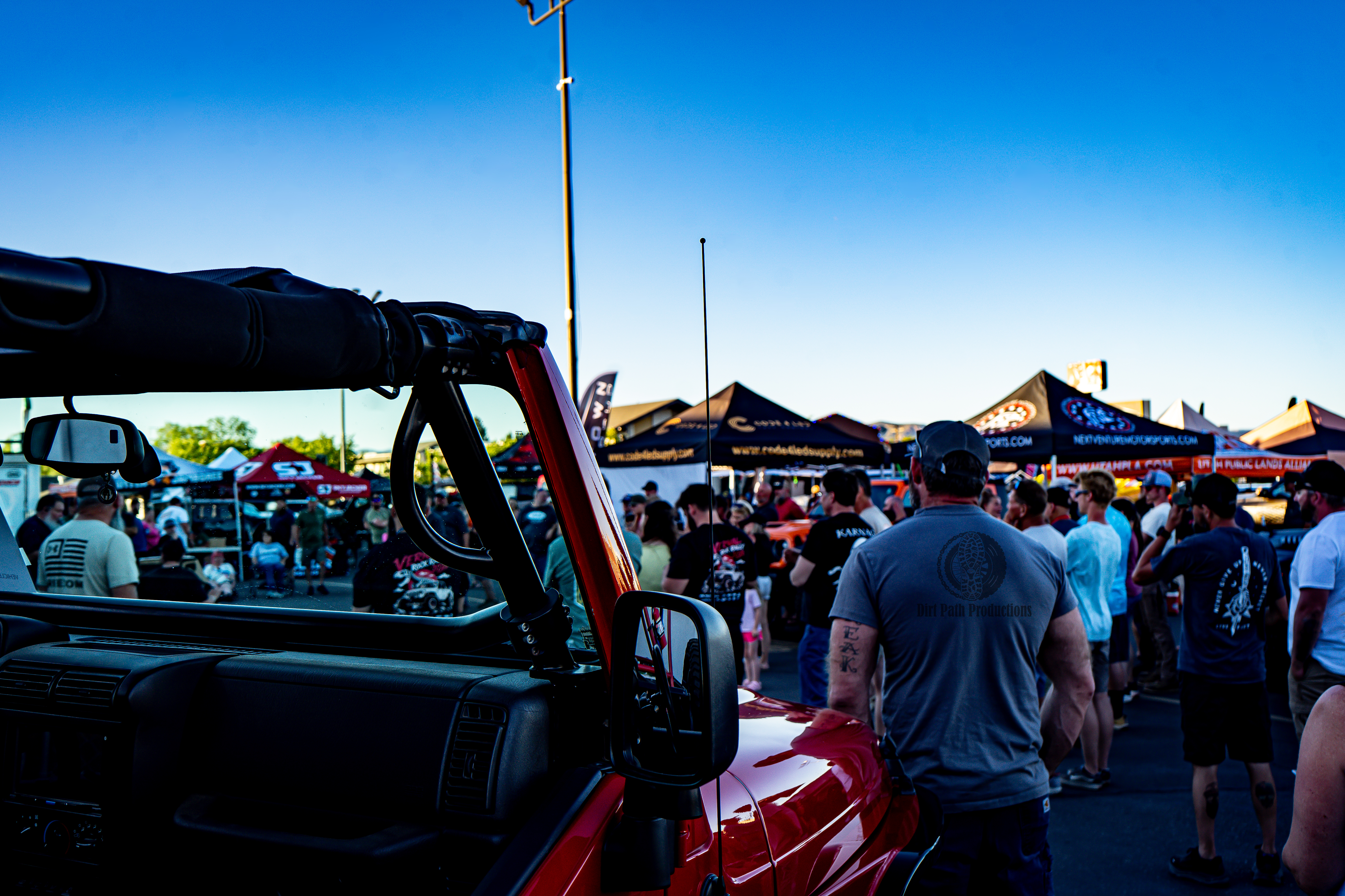 Crowd gathered at an outdoor off-road rock rally event