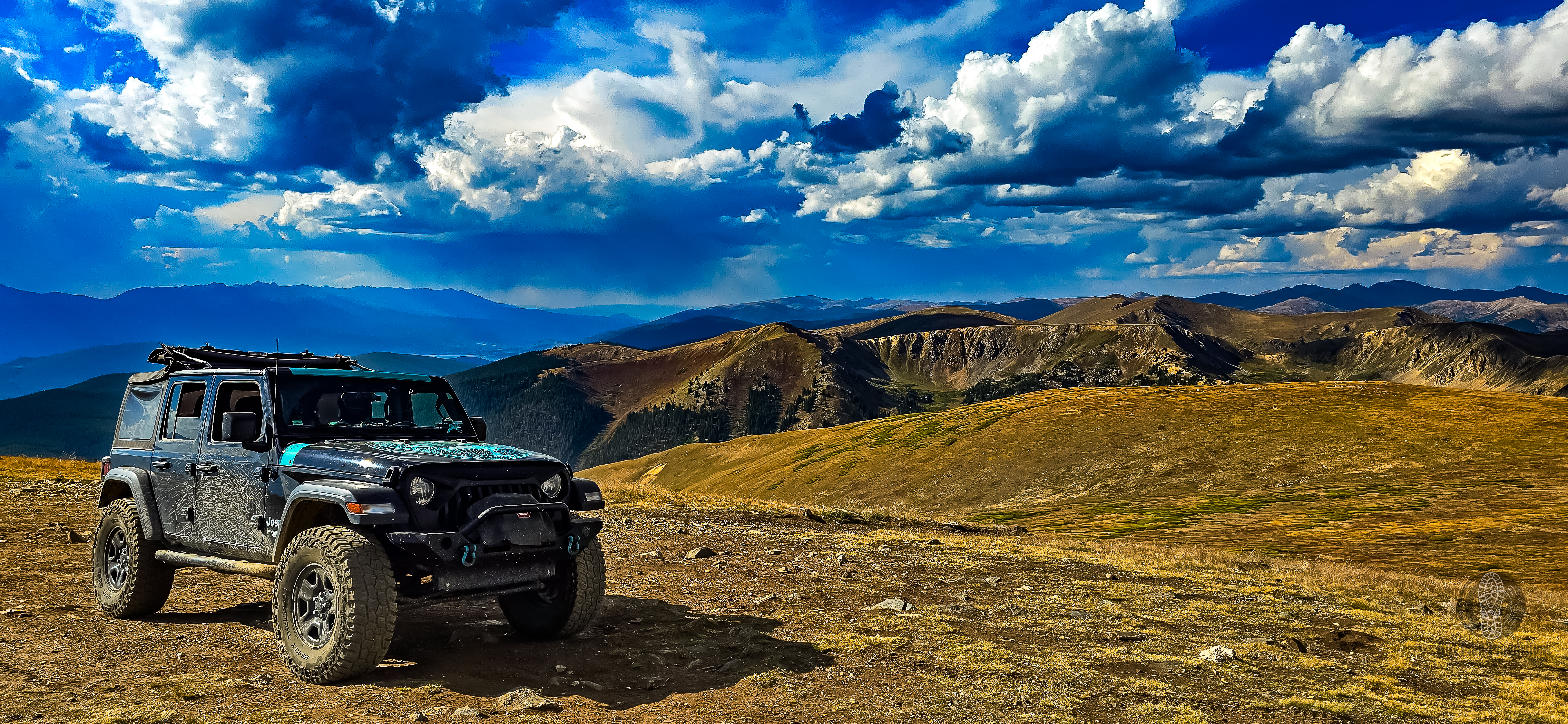 Jeep above treeline with panoramic Colorado mountain views